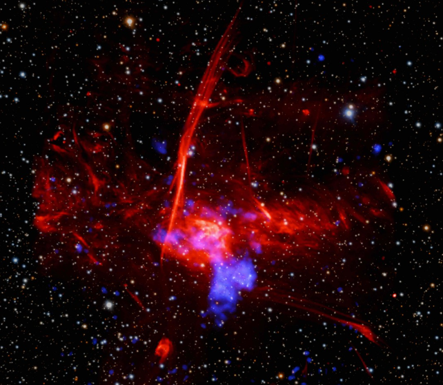 L’immagine composita include raggi X raccolti da Chandra e Xmm-Newton (blu) e dati radio dal telescopio MeerKat (rosso) in Sudafrica, combinati con un’immagine ottica dai telescopi Pan-Starrs alle Hawaii (rosso, verde e blu). Crediti: Chandra, Xmm, MeerKat